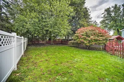 a backyard with a white fence and a yard at Pet-Friendly Latham Retreat about 7 Mi to Albany! in Latham