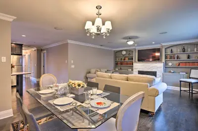 a dining room and living room with a table and a couch at 25 Mi to NYC Cozy Long Island Apt Near Transit in Glen Cove