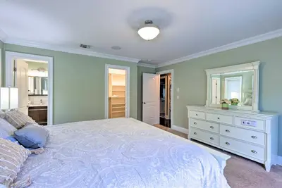 a bedroom with a bed and a dresser and mirror at 25 Mi to NYC Cozy Long Island Apt Near Transit in Glen Cove