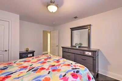 a bedroom with a bed and a dresser and a mirror at 25 Mi to NYC Cozy Long Island Apt Near Transit in Glen Cove
