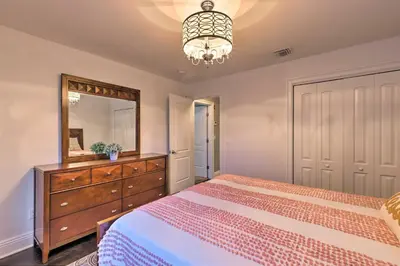 a bedroom with a bed and a dresser and a mirror at 25 Mi to NYC Cozy Long Island Apt Near Transit in Glen Cove