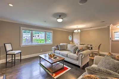 a living room with a couch and a table at 25 Mi to NYC Cozy Long Island Apt Near Transit in Glen Cove