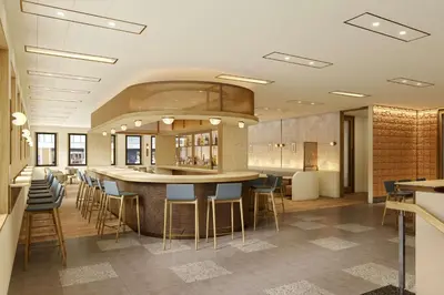 a lobby with a bar with blue stools at Hotel Marcel New Haven, Tapestry Collection By Hilton in New Haven