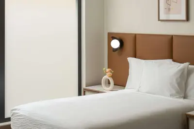 a bedroom with a large white bed and a window at Hotel Marcel New Haven, Tapestry Collection By Hilton in New Haven
