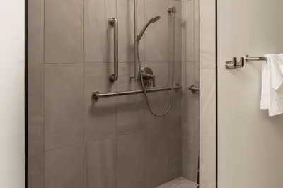 a shower stall in a bathroom with a glass door at Hotel Marcel New Haven, Tapestry Collection By Hilton in New Haven