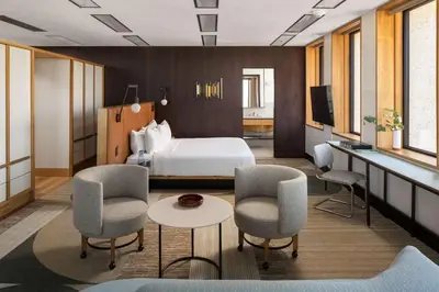 a hotel room with a bed and chairs and a table at Hotel Marcel New Haven, Tapestry Collection By Hilton in New Haven