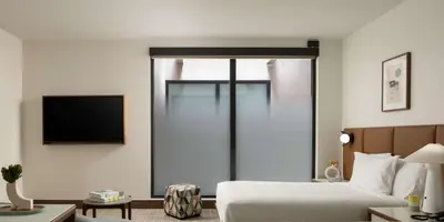 a hotel room with a bed and a television at Hotel Marcel New Haven, Tapestry Collection By Hilton in New Haven