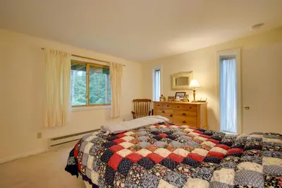 a bedroom with a bed and a dresser and a window at Dover Condo with Grill and Balcony 3 Mi to Mt Snow! in Dover