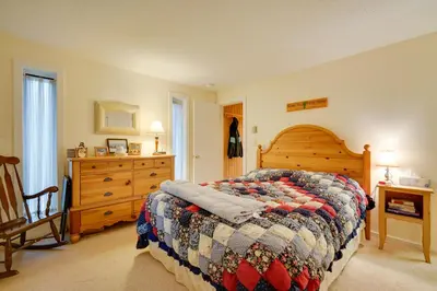 a bedroom with a bed and a chair and a dresser at Dover Condo with Grill and Balcony 3 Mi to Mt Snow! in Dover