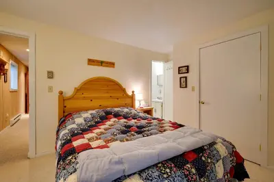 a bedroom with a bed with a quilt on it at Dover Condo with Grill and Balcony 3 Mi to Mt Snow! in Dover