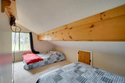 a bedroom with two beds and a large window at Dover Condo with Grill and Balcony 3 Mi to Mt Snow! in Dover