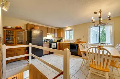 a kitchen and dining room with a table and chairs at Dover Condo with Grill and Balcony 3 Mi to Mt Snow! in Dover