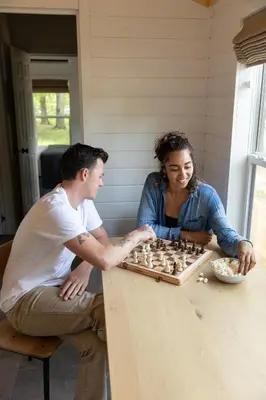 a man and a woman playing a game of chess at AutoCamp Catskills in Saugerties
