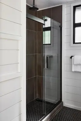 a shower with a glass door in a bathroom at AutoCamp Catskills in Saugerties