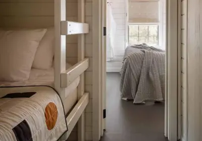 a bedroom with a bunk bed and a window at AutoCamp Catskills in Saugerties