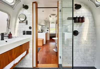 a bathroom with a sink and a glass shower at AutoCamp Catskills in Saugerties