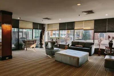 a living room with a couch and a table at Stamford Suites in Stamford