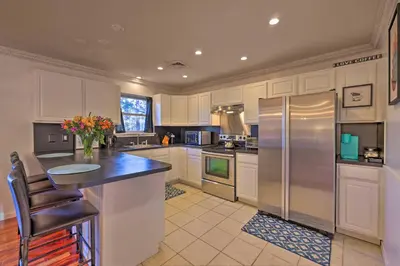 a large kitchen with a refrigerator and a counter at Resort Perks and Lake Access Poconos Retreat in Pocono Summit