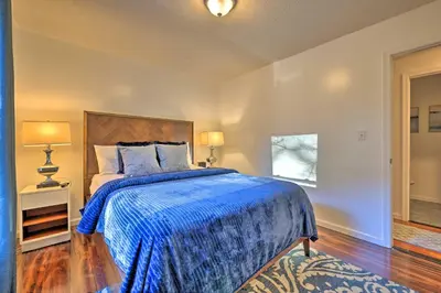 a bedroom with a bed with a blue comforter at Resort Perks and Lake Access Poconos Retreat in Pocono Summit