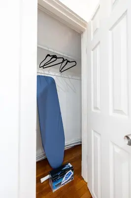 a blue surfboard is sitting in a closet at Gorgeous 3 bedroom - 9 mins to Hartford, Connecticut in West Hartford