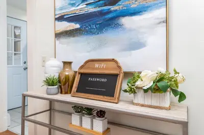 a console table with a chalkboard sign on it at Gorgeous 3 bedroom - 9 mins to Hartford, Connecticut in West Hartford