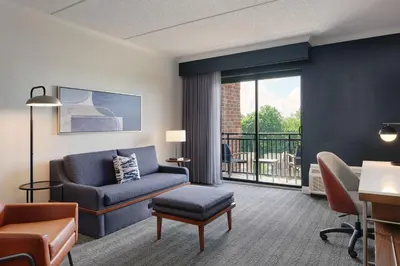 a living room with a couch and a chair at Courtyard by Marriott Saratoga Springs in Saratoga Springs