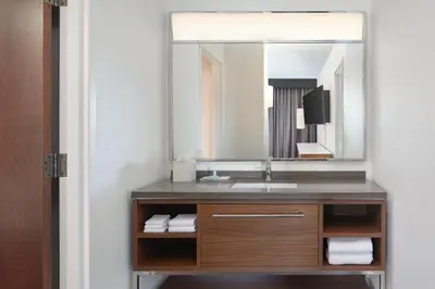 a bathroom with a sink and a mirror at Courtyard by Marriott Saratoga Springs in Saratoga Springs