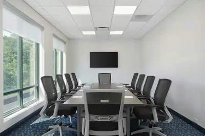 a conference room with a long table and chairs at Courtyard by Marriott Saratoga Springs in Saratoga Springs