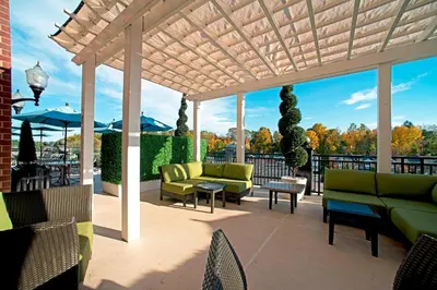 a pergola with couches and tables on a patio at Courtyard by Marriott Saratoga Springs in Saratoga Springs