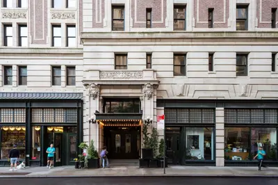 a building with people walking in front of it at Ace Hotel New York in New York