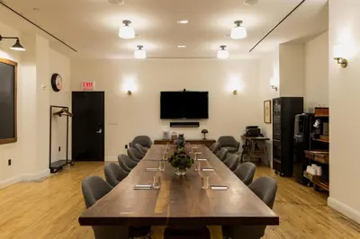 a large conference room with a long table and chairs at Ace Hotel New York in New York