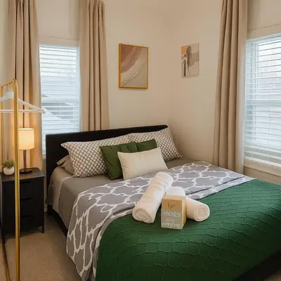 a bedroom with a bed with a green comforter at Modern Room in Shared Apartment Near NYC in Englewood