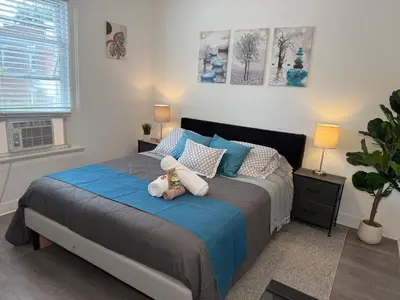 a bedroom with a bed with a teddy bear on it at Modern Room in Shared Apartment Near NYC in Englewood