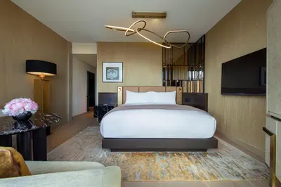a hotel room with a bed and a flat screen tv at The Ritz-Carlton New York, NoMad in New York