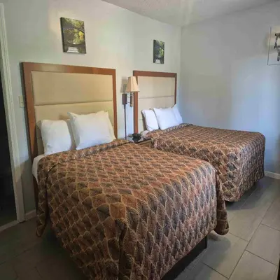 a hotel room with two beds in a room at Maple leaf motel in New Milford