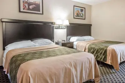 a hotel room with two beds in it at Econo Lodge in West Haven