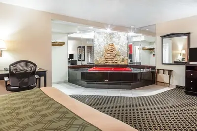 a hotel room with a bed and a tub at Econo Lodge in West Haven