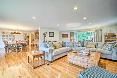 a living room with a couch and a table at Family Winter Retreat with Hot Tub 14 Mi to Slopes! in Whitingham