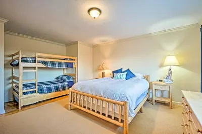 a bedroom with two bunk beds and a lamp at Family Winter Retreat with Hot Tub 14 Mi to Slopes! in Whitingham