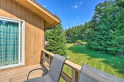 two chairs sitting on the porch of a house at Family Winter Retreat with Hot Tub 14 Mi to Slopes! in Whitingham