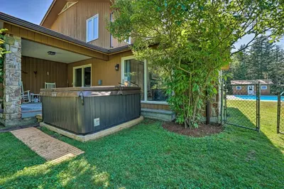 a house with a hot tub in the yard at Family Winter Retreat with Hot Tub 14 Mi to Slopes! in Whitingham