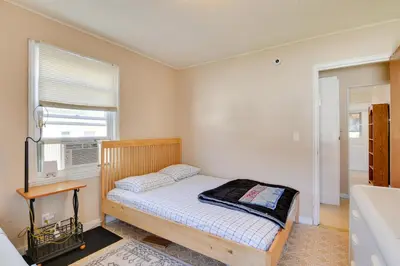 a small bedroom with a bed and a window at Shared Boat Launch Lake Retreat in Ellenville! in Ellenville