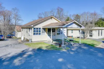 a white house with a picnic table in front of it at Shared Boat Launch Lake Retreat in Ellenville! in Ellenville