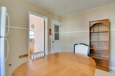a dining room with a wooden table and chairs at Shared Boat Launch Lake Retreat in Ellenville! in Ellenville