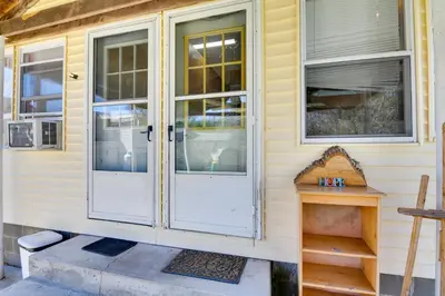 a house with a white door and windows at Shared Lake Access and Fire Pit Catskills Getaway! in Ellenville