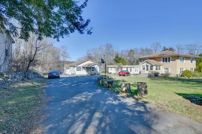 a street in a residential neighborhood with a house at Shared Fire Pit and Kayaks Catskills Lake Retreat! in Ellenville