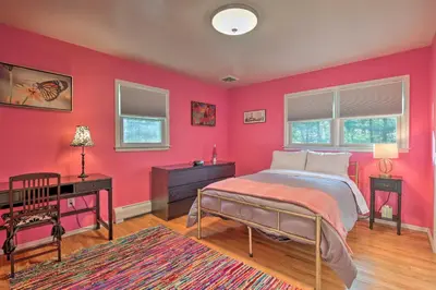 a bedroom with pink walls and a bed and a desk at Family-Friendly Woodbury Home with Yard and Deck! in Woodbury