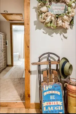 a hallway with a wreath on the wall and a bag at The Nook Lodge - cabin with hot tub at Shawnee and Camelback Mtn in East Stroudsburg