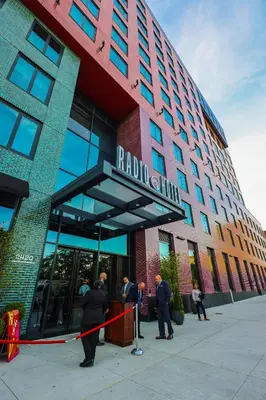 a group of people standing outside of a building at Radio Hotel in New York