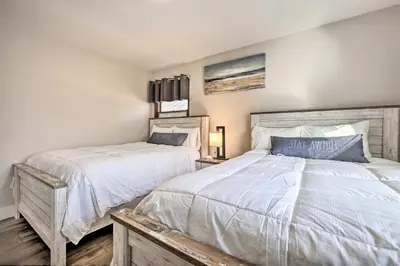 a bedroom with two beds with white sheets at Modern East Stroudsburg Home with Pool and Fire Pit in East Stroudsburg